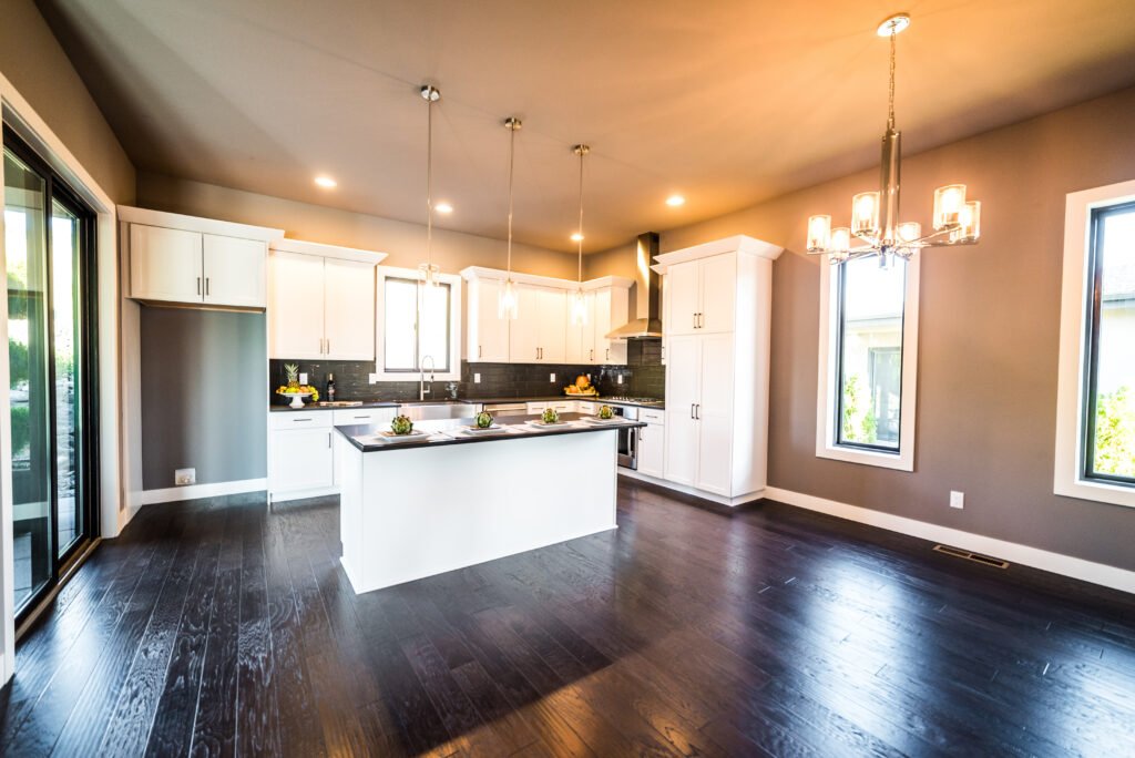 Open-concept kitchen remodel with island, white cabinets, and dark hardwood floors — Genuine Kitchen and Bath, San Mateo County