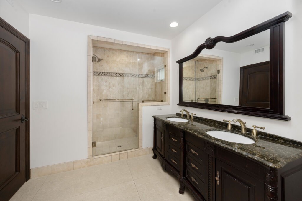 Master bathroom remodel in San Mateo County featuring walk-in glass shower, custom tile, double vanity with granite countertop — by Genuine Kitchen and Bath